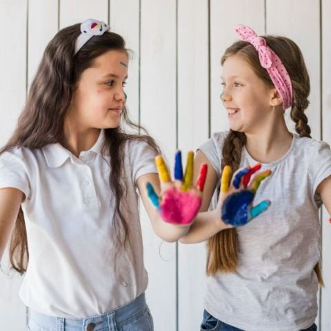 two-girls-showing-colorful-painted-hand-looking-each-other (1) (1) (1)